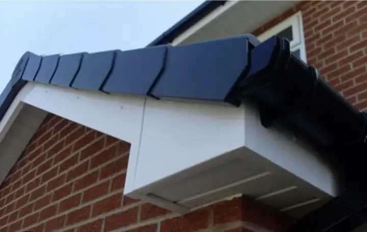 Black dry verge caps over a new white uPVC box end on a brick gable