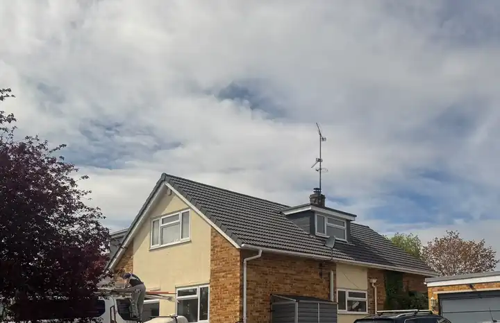 Side view of a chalet bungalow with its new grey tile roof