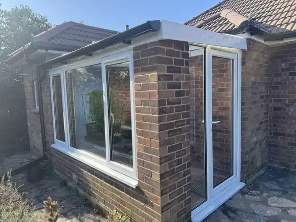 Single-storey brick extension with new white fascia and gutter under a tiled roof