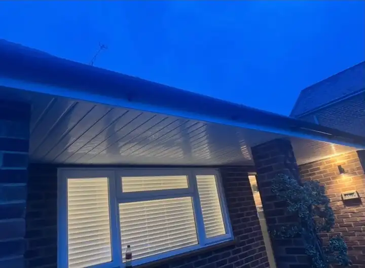 New white uPVC soffit with LED downlights over a bay window in Fleet