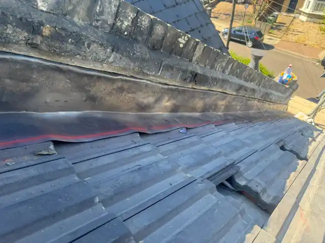 Lead flashing dressed along a parapet abutment