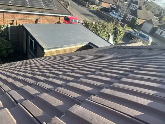 New concrete tile roof looking out over a garage roof