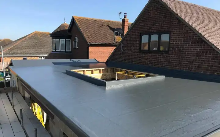 New grey flat roof with an opening framed for a roof light