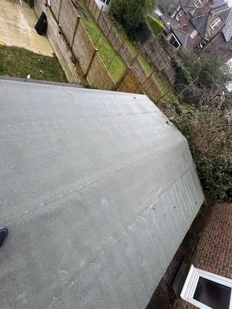 New grey flat roof covering on a single-storey extension