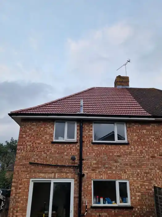 Rear of a semi-detached house with its new red tile hipped roof