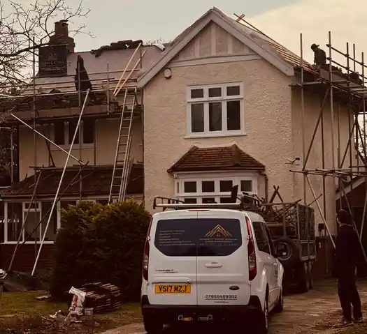 Large house under scaffold for a re-roof with McDermott van outside
