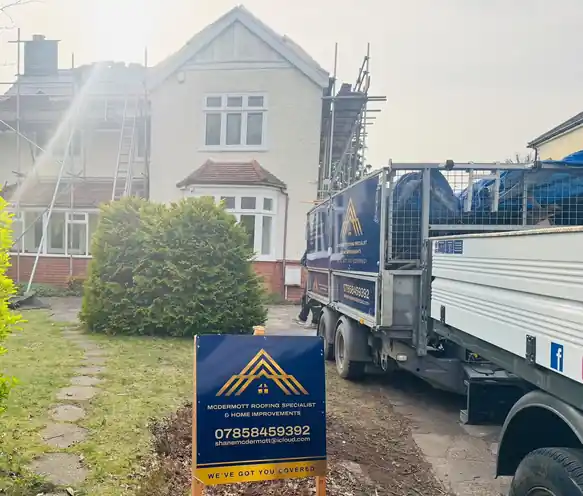 McDermott site sign and truck at a detached house under scaffold