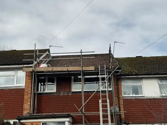 Terraced house under scaffold for roof repairs