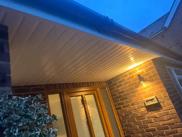 New uPVC soffit with LED downlights over a porch at dusk