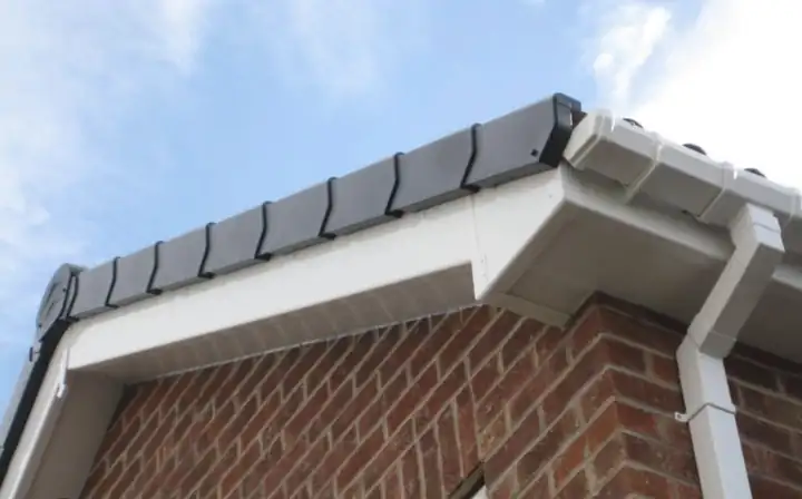 New white uPVC fascia, soffit and gutter with dry verge caps on a brick gable end
